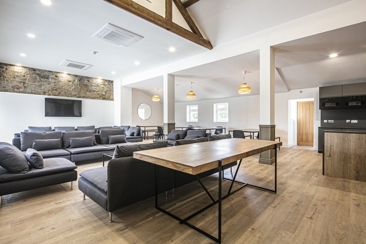 Dovedale Manor - a vast open plan living room with dining tables and incorporating the kitchen